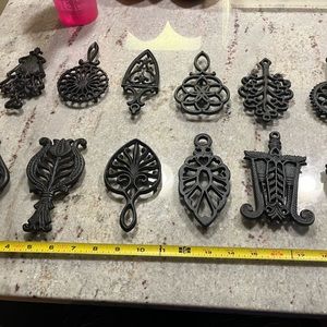 Lot of 12 Wilton Cast Iron Trivets, all about 4-5 inches tall